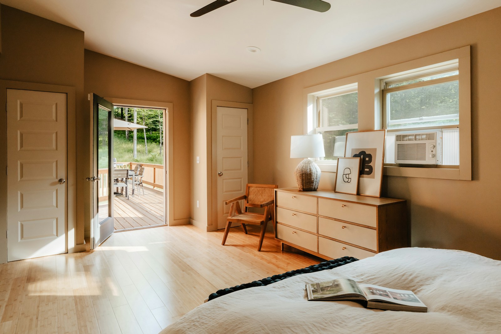 A bedroom with a large bed and a ceiling fan