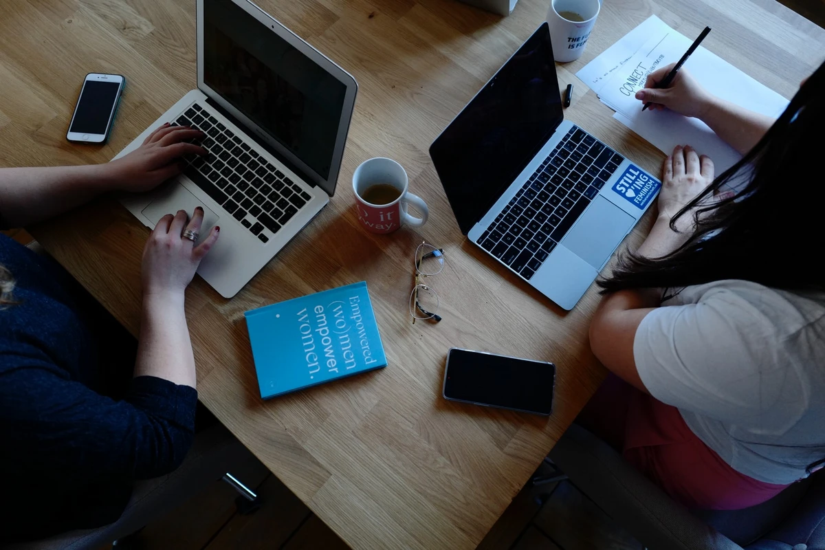 two person using laptops