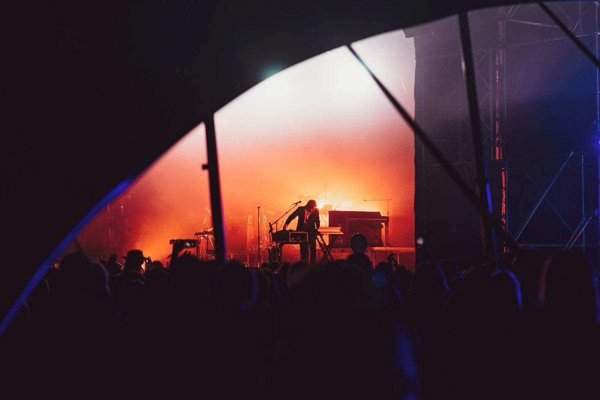 person standing on stage in front of crowd