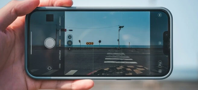 a person taking a picture of a street with a cell phone